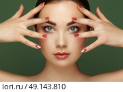 Beauty brunette woman with perfect makeup. Glamour girl. Red lips and nails. Perfect eyebrows. Skin care foundation. Beauty girls face isolated on green background. Fashion photo. Стоковое фото, агентство Ingram Publishing / Фотобанк Лори