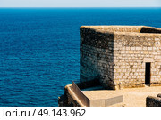 Old Castle Stone Wall And Tower With Ocean Background. Стоковое фото, агентство Ingram Publishing / Фотобанк Лори