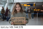 Smiling girl holding a "Welcome Home" sign at airport arrivals, expressing joy and warmth while waiting for a loved one in a busy, modern terminal. Стоковое AI-изображение, AI-художник Катерина Бондарец / Фотобанк Лори
