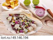 Ceviche peruvian recipe with fried banana and ingredients on wooden table. Стоковое фото, агентство Ingram Publishing / Фотобанк Лори