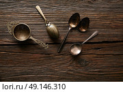 Vintage retro tea Strainers silver brass on wooden background. Стоковое фото, агентство Ingram Publishing / Фотобанк Лори
