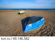Valencia La Malvarrosa beach arenas beached boats in Spain. Стоковое фото, агентство Ingram Publishing / Фотобанк Лори