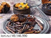 Healing gathering roots and herb. Medicinal herbs of folk medicine comfrey, inonotus obliquus and calendula. Стоковое фото, агентство Ingram Publishing / Фотобанк Лори