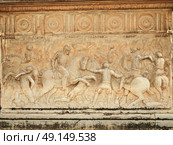 Alhambra, wall of Carlos V Palace. Relief carving of a battle scene. Стоковое фото, агентство Ingram Publishing / Фотобанк Лори