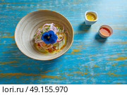 Fish ceviche latin preuvian recipe on bowl with pansy flower. Стоковое фото, агентство Ingram Publishing / Фотобанк Лори
