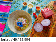 Fish ceviche latin preuvian recipe on bowl with pansy flower. Стоковое фото, агентство Ingram Publishing / Фотобанк Лори
