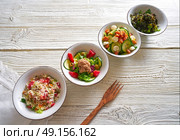 four salad mix bowls healthy food on white wood table. Стоковое фото, агентство Ingram Publishing / Фотобанк Лори
