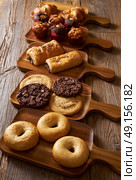Pastries in a row Croissant Muffin Cookie Bagel and Neapolitan bakery. Стоковое фото, агентство Ingram Publishing / Фотобанк Лори