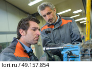 Two middle aged mechanics at work. Стоковое фото, агентство Ingram Publishing / Фотобанк Лори