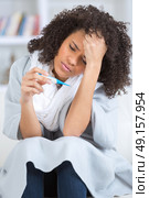 sick girl with fever checking mercury thermometer. Стоковое фото, агентство Ingram Publishing / Фотобанк Лори