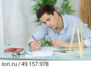 young handsome artist practise drawing as a hobby. Стоковое фото, агентство Ingram Publishing / Фотобанк Лори