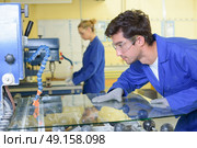 young qualified people forced to work at the factory. Стоковое фото, агентство Ingram Publishing / Фотобанк Лори