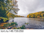 Trees in autumn colors around a lake in scandinavia in october in beautiful yellow and orange autumn colors. Стоковое фото, агентство Ingram Publishing / Фотобанк Лори