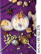 Masala tea ingredients. glass of Indian tea with milk and spicy spices. Стоковое фото, агентство Ingram Publishing / Фотобанк Лори