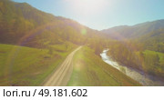 Low altitude flight over fresh fast mountain river with rocks at sunny summer morning. Стоковое видео, видеограф Александр Маркин / Фотобанк Лори