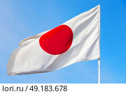 waving flag in the blue sky japancolour and wave. Стоковое фото, агентство Ingram Publishing / Фотобанк Лори