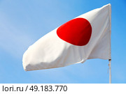 waving flag in the blue sky japancolour and wave. Стоковое фото, агентство Ingram Publishing / Фотобанк Лори