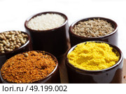 Spices and herbs in ceramic bowls. seasoning. Colorful natural additives. Стоковое фото, агентство Ingram Publishing / Фотобанк Лори