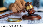A judges gavel resting on top of a magnifying glass, symbolizing detailed examination and decision-making in the legal field. Стоковое AI-изображение, AI-художник Данила Большаков / Фотобанк Лори