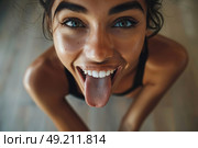 Charming woman playfully sticks out her tongue in a humorous expression, showcasing a lighthearted moment of fun and silliness. Стоковое AI-изображение, AI-художник Данила Большаков / Фотобанк Лори