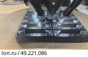 3 d printer makes prints parts from black plastic material,3D printer in operation close-up. Automatic three dimensional 3d printing performs plastic modeling in laboratory. The 4ht industrial. Стоковое видео, видеограф Куликов Константин / Фотобанк Лори