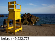 garbage basket yellow lifeguard chair cabin  in lanzarote  spain   rock stone sky cloud beach  water  musk pond  coastline and summer . Стоковое фото, агентство Ingram Publishing / Фотобанк Лори