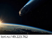 A large meteor descends towards the Earth against the backdrop of a sunrise at the edge of space. Стоковое AI-изображение, AI-художник Данила Большаков / Фотобанк Лори
