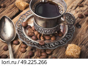 Coffee in the oriental style. Vintage set with a cup of coffee on saucer in oriental style. Стоковое фото, агентство Ingram Publishing / Фотобанк Лори