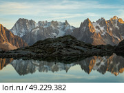 Silhouette of Hiker, Mountains and Reflection in Lac Blanc Lake at Sunset. Golden Hour. French Alps, France. Стоковое фото, фотограф Максим Забаровский / Фотобанк Лори