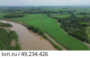 Big River Surrounded by Farmland. Стоковое видео, видеограф ALEJANDRO PEREZ ALVARES / Фотобанк Лори