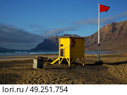 lifeguard chair red flag in spain  lanzarote  rock stone sky cloud beach  water  musk pond  coastline and summer . Стоковое фото, агентство Ingram Publishing / Фотобанк Лори