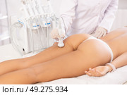 Aesthetician administering high frequency ultrasound procedure on buttocks of female patient. Стоковое фото, фотограф Яков Филимонов / Фотобанк Лори