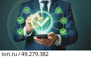 A person in a business suit working on a smartphone with virtual icons related to successful transactions, including a glowing green checkmark. Стоковое AI-видео, аниматор Sergey Grishin / Фотобанк Лори