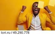A cheerful man in a vibrant yellow suit exults with raised fists and a broad smile. Стоковое AI-изображение, AI-художник Данила Большаков / Фотобанк Лори