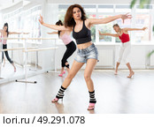 Female dancer performing sensual choreography in high heels at group rehearsal. Стоковое фото, фотограф Яков Филимонов / Фотобанк Лори