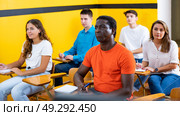 Lesson in the classroom of the driving school - students at their desks and take a theoretical course of work in taxi. Стоковое фото, фотограф Яков Филимонов / Фотобанк Лори