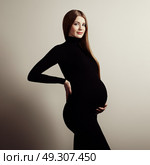 Portrait of the young pregnant woman. Pregnancy, love, people and expectation concept. Happy pregnant lady with long hair. Стоковое фото, агентство Ingram Publishing / Фотобанк Лори