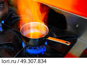 Flaming Cooking Pan in restaurant kitchen with fire. Стоковое фото, агентство Ingram Publishing / Фотобанк Лори