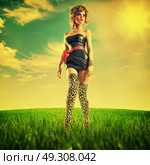 Pretty blond woman walking on the summer meadow. Стоковое фото, агентство Ingram Publishing / Фотобанк Лори