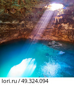 Cenote Samula sinkhole light beam near Valladolid in Yucatan Mexico. Стоковое фото, агентство Ingram Publishing / Фотобанк Лори