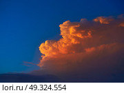 Sunset sky orange clouds on blue colorful Caribbean cloudscape. Стоковое фото, агентство Ingram Publishing / Фотобанк Лори