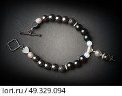 jewel handmade bracelet with semipreciouse stones at black background. Стоковое фото, агентство Ingram Publishing / Фотобанк Лори