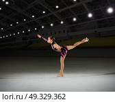 Young woman figure skater at sports hall. Стоковое фото, агентство Ingram Publishing / Фотобанк Лори