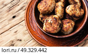 tasty homemade cutlets. homemade rissole in clay ware on a wooden background. Стоковое фото, агентство Ingram Publishing / Фотобанк Лори