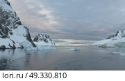 Big Iceberg in Antarctica Winter Scenery, Amazing Shape Ice Formation of Massive Large Enormous Blue Icebergs in Antarctic Peninsula Landscape Seascape with Ocean Sea Water. Стоковое видео, видеограф Vladimir / Фотобанк Лори