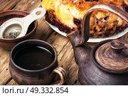 tea-party with rustic pastries. Clay tea ware with tea and homemade cake pie. Стоковое фото, агентство Ingram Publishing / Фотобанк Лори