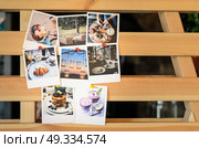 photos with Polaroid about food and journey pinned to a wooden lattice. Стоковое фото, агентство Ingram Publishing / Фотобанк Лори
