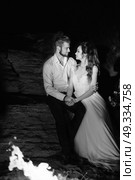 young couple the bride and groom warm around the fire at night. Стоковое фото, агентство Ingram Publishing / Фотобанк Лори