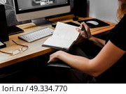 designer girl at work at the table draws on the tablet, close the keypad, printer, computer. Стоковое фото, агентство Ingram Publishing / Фотобанк Лори