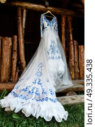 bridesmaid dress in the style of Gzhel hanging on a wooden beam in the input aperture of the house. Стоковое фото, агентство Ingram Publishing / Фотобанк Лори